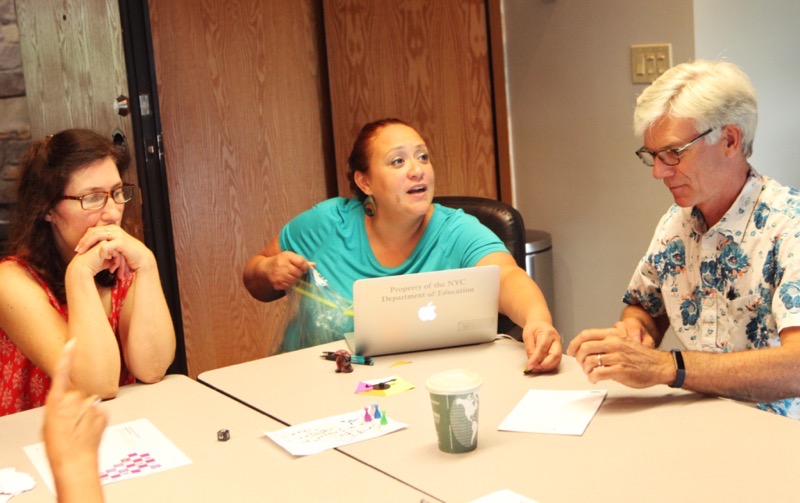 Three people sitting around a table