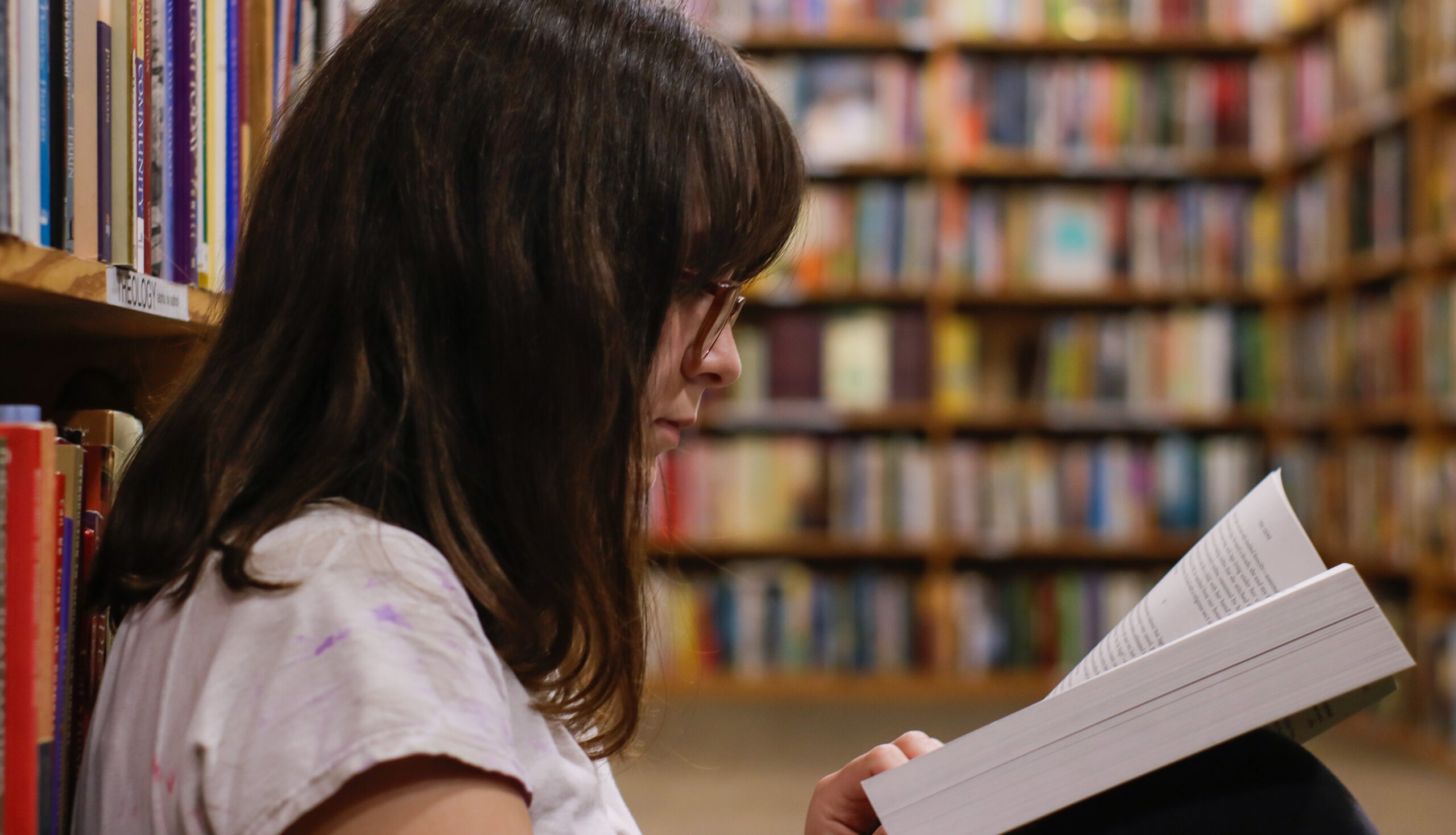 woman reading a book in a library