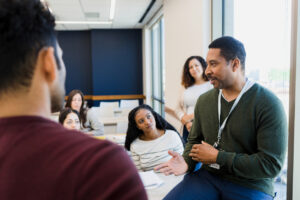 Faculty member talks with students